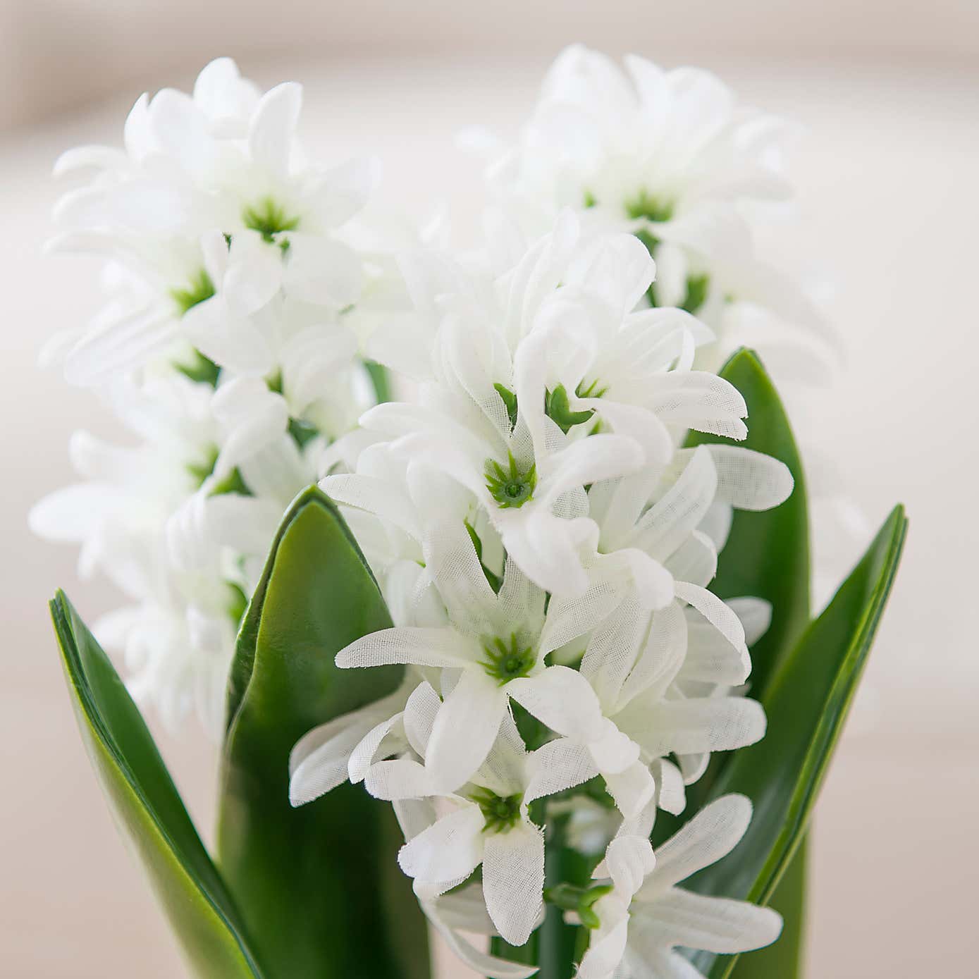 Artificial White Hyacinth in Ribbed Green Ceramic Plant Pot