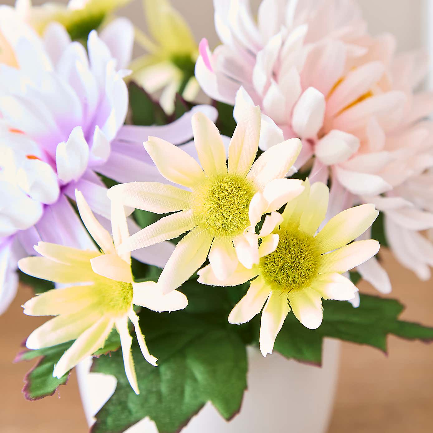 Artificial Floral Arrangement in White Ceramic Plant Pot