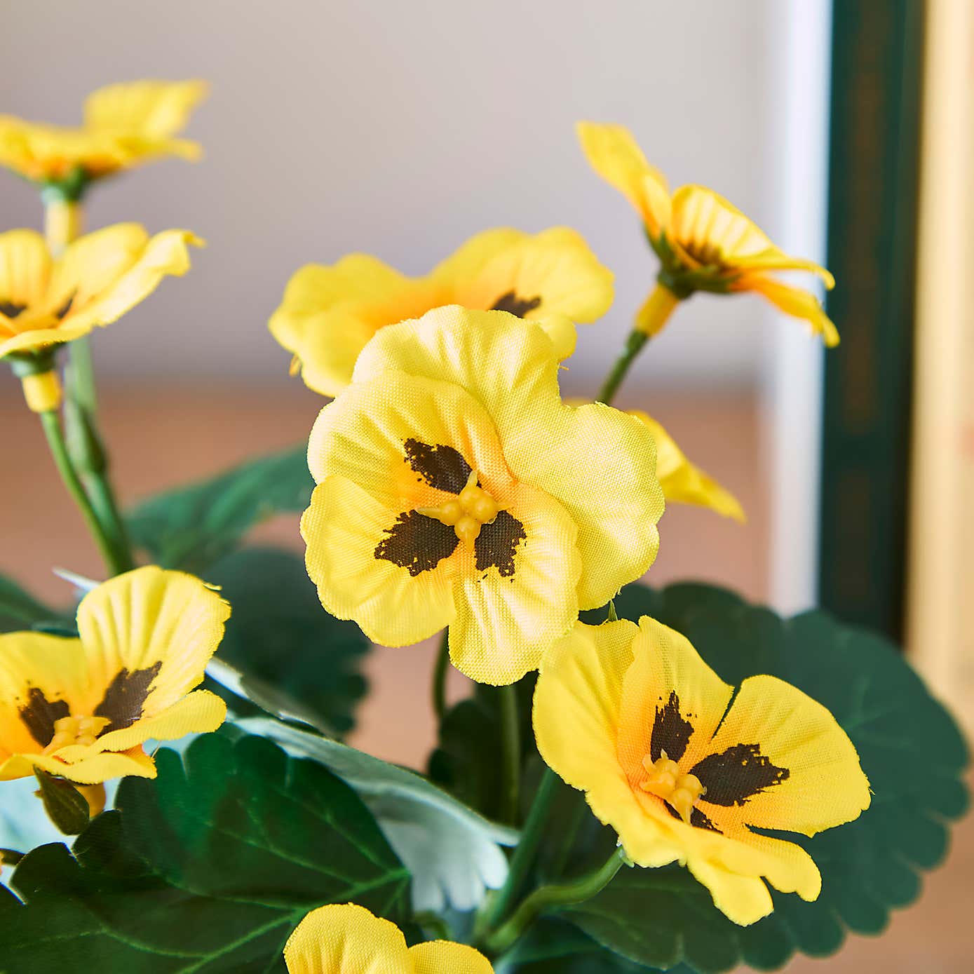 Artificial Yellow Pansy in White Ceramic Plant Pot