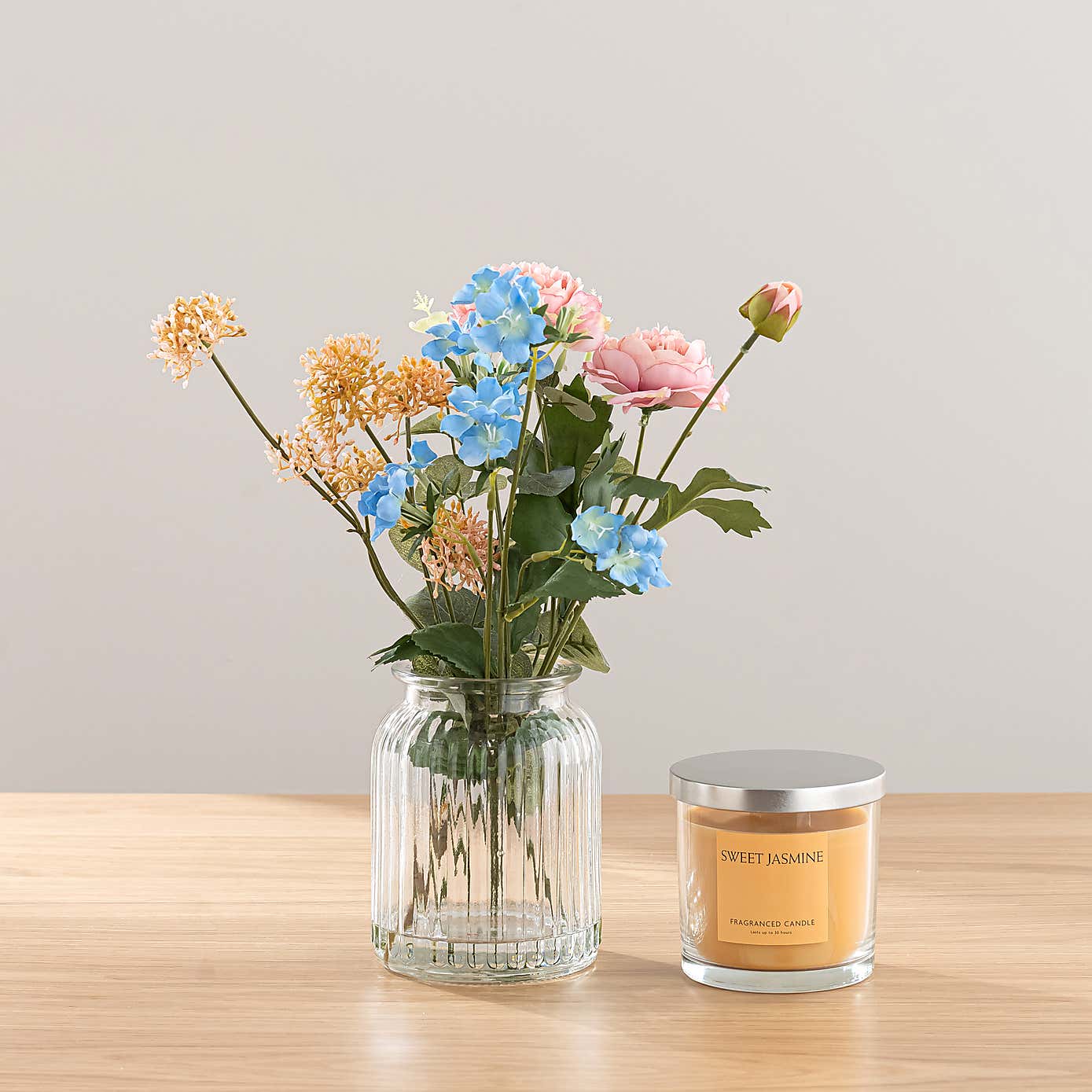 Pink Ranunculus Floral Arrangement in Ribbed Glass Vase with Sweet Jasmine Candle